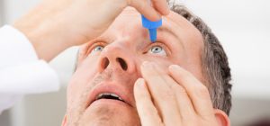 Man Putting Droplets in His Eye - Chronic Dry Eyes