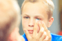 child putting in contact lens